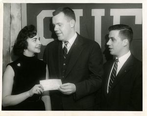 Boston Mayor John B. Hynes (JD 1927) gives a donation to Suffolk University's Christmas Fund