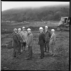 Kevin Lamb, Principal of Newcastle Integrated School, with staff and builders on the site before work started, pupils at temporary school in Dundrum prior to new school being opened, and images of the site
