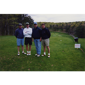 A four-man golf team posing at the Charlestown Boys and Girls Club Annual Golf Tournament