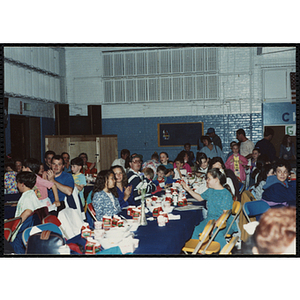 Children and adults seated together at a Kiwanis Awards Night