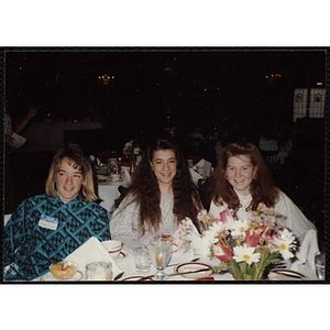 Three girls seated together, including Kolleen Hayes, on the left, at the "Recognition Dinner at Harvard Club"