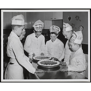 Members of the Tom Pappas Chefs' Club pose with pies in the Shearton Plaza Hotel testing kitchen