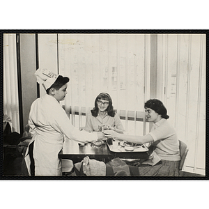 A member of the Tom Pappas Chefs' Club serves diners in a Brandeis University dining hall