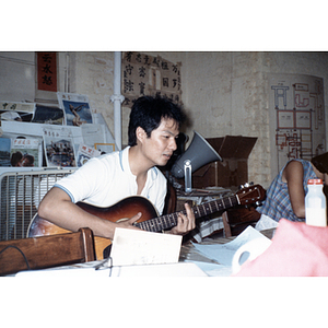 Association member playing a guitar