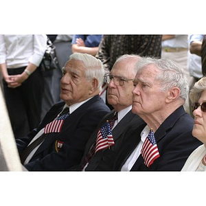 Three men with flags in the audience of the Veterans Memorial groundbreaking ceremony