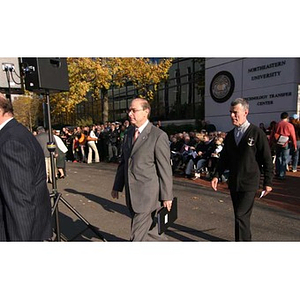 President Aoun and another man walk over from Egan Research Center to the Veterans Memorial dedication ceremony