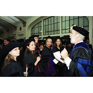 A professor speaking to law students before commencement