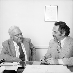 Two College of Education faculty speaking to one another