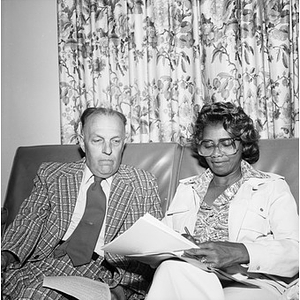 Two College of Education faculty looking at papers together