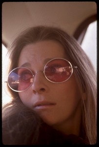 Judy Collins: portrait in rose-colored glasses, seated in the back of car