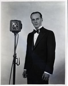 Howard Claney, next to NBC radio microphone