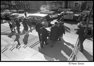 Jack Kerouac's funeral: pallbearers carrying casket down church steps, Allan Ginsberg center-right, Jeff Albertson with camera on right