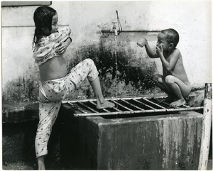 Two children washing up