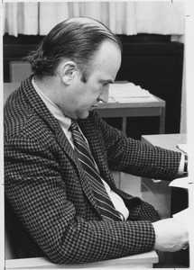 David A. Booth sitting at desk