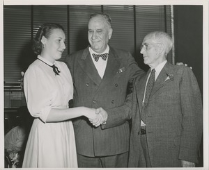 John N. Smith and woman and man shaking hands