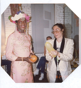 A Photograph of Marsha P. Johnson Standing with Her Friend, Holding Balloons at Her Birthday Party