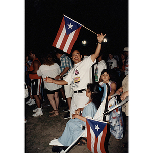 A man waves a Puerto Rican flag at the Festival Puertorriqueño