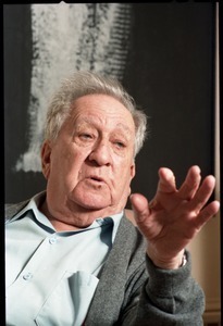 Fine art photographer Aaron Siskind: close-up portrait, seated in a armchair in his living room