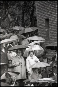 Crowd, with umbrellas, awaiting the arrival of Gerald Ford to dedicate the Old Great Falls Historic District as a national historic landmark