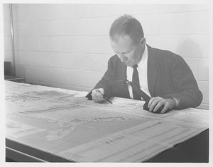 Harold Theodore Uhr Smith studying geological map