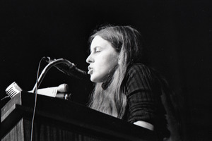 Bernadette Devlin McAliskey at the podium during a talk at Northeastern University