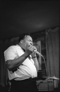 James Cotton at Club 47: James Cotton playing harmonica onstage with his eyes closed