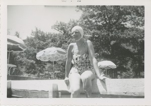 Bernice Kahn seated on dock in her bathing suit