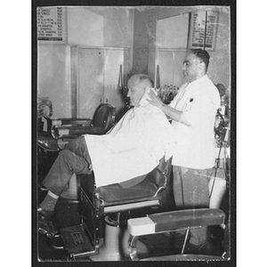 Barber standing behind customer in chair