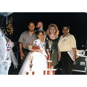 Group portrait of a young beauty queen surrounded by family and presenters at Festival Betances.