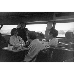 Villa Victoria residents enjoying a meal on board a Boston Harbor Cruises boat during a community outing.