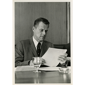 Richard Harte, Jr. reviewing documents at a Boys' Club meeting