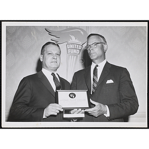 William J. Lynch, at left, receives the United Fund Award for outstanding citizenship