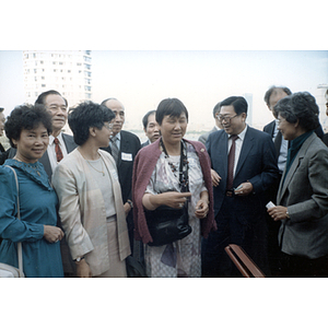 Suzanne Lee and other members of the Chinese Progressive Association stand with the Vice Governor of Guangdong Province and others