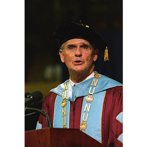 President John Curry speaking from the podium at commencement