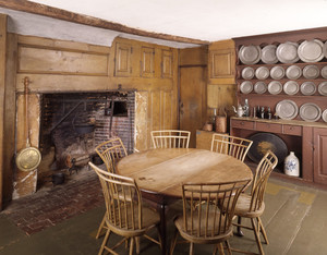 View of the kitchen showing fireplace, table and pewter cupboad, Coffin House, Newbury, Mass.