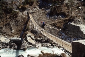 Sandi Sommer crossing Dudh Khosi River on swinging bridge