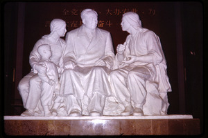 Agricultural exhibition(?): sculpture of Mao seated with a family