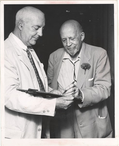 W. E. B. Du Bois signing a petition held by John T. McManus