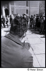 Street theater (part of a mock execution) in front of Marsh Chapel, Boston University: 'dead' body and men wearing masks