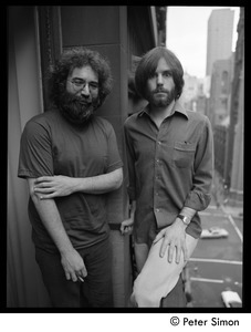 Jerry Garcia (left) and Bob Weir of the Grateful Dead standing on a balcony