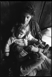 Woman seated with a child in her lap, Brotherhood of the Spirit commune