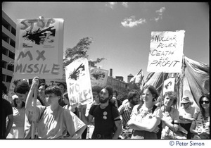 Protesters at a Mobilization for Survival antinuclear demonstration near Draper Laboratory, MIT, carrying signs opposing the MX missile and nuclear power