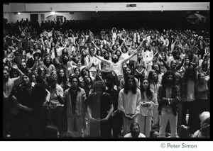 Audience in the Winterland Ballroom raising their arms in ecstasy, listening to Amazing Grace during the Ram Dass 'marathon'