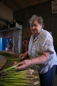 Hibbard Farm: woman at a round table, sorting and bunching asparagus