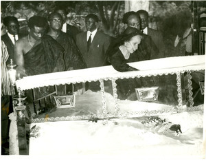 Shirley Graham Du Bois bent over open casket at state funeral for W. E. B. Du Bois