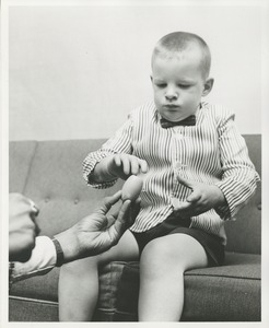 A young boy uses his new prosthetic hand