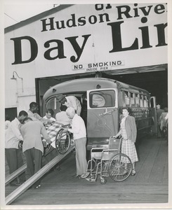 Wheelchair users unloading from bus