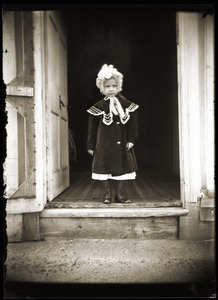Infant girl standing in open doorway (Greenwich, Mass.)