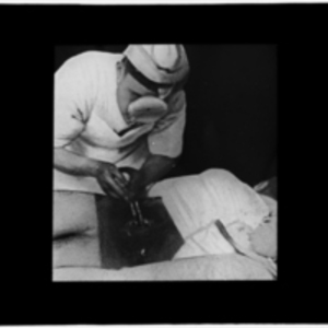 Reproduction of photograph of a surgeon operating on a spine