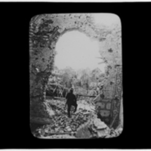 Soldier posing in a hole in a wall